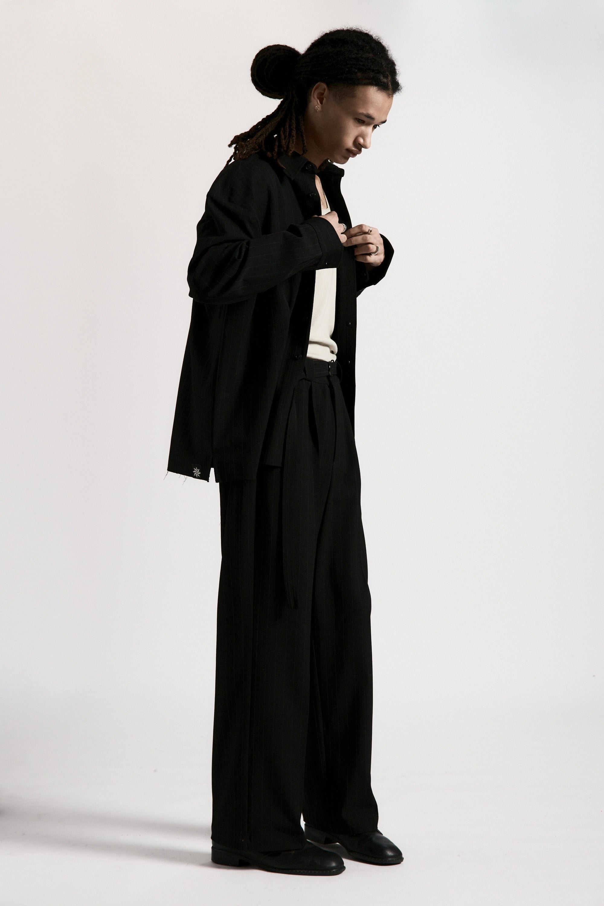 Person wearing a black outfit on a white background