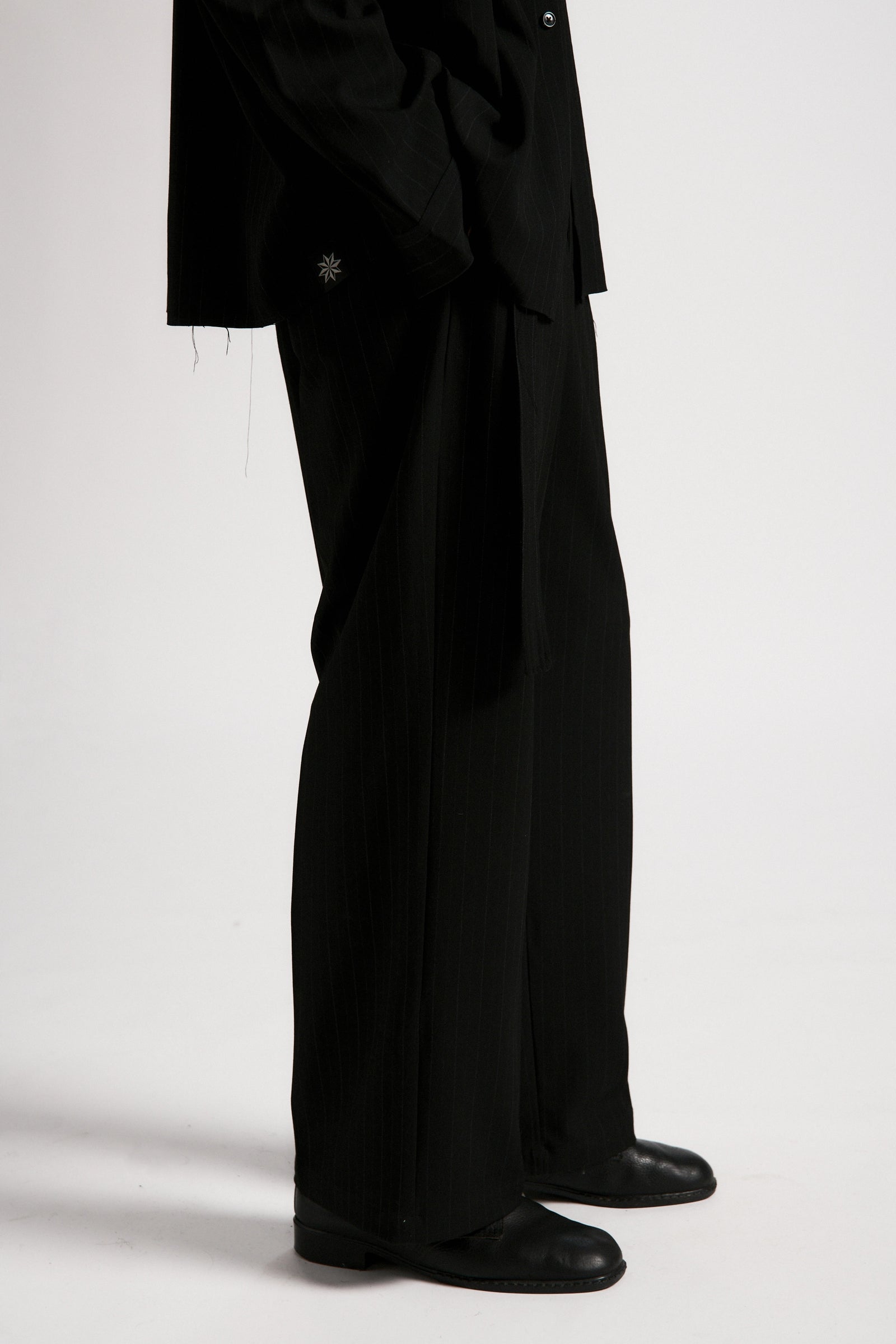 Black suit with a white background