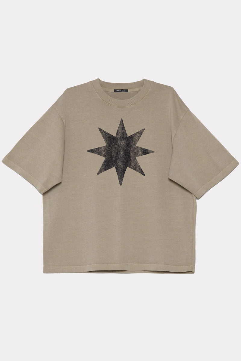 Beige t-shirt made from 320GSM cotton jersey with a black star design on a white background