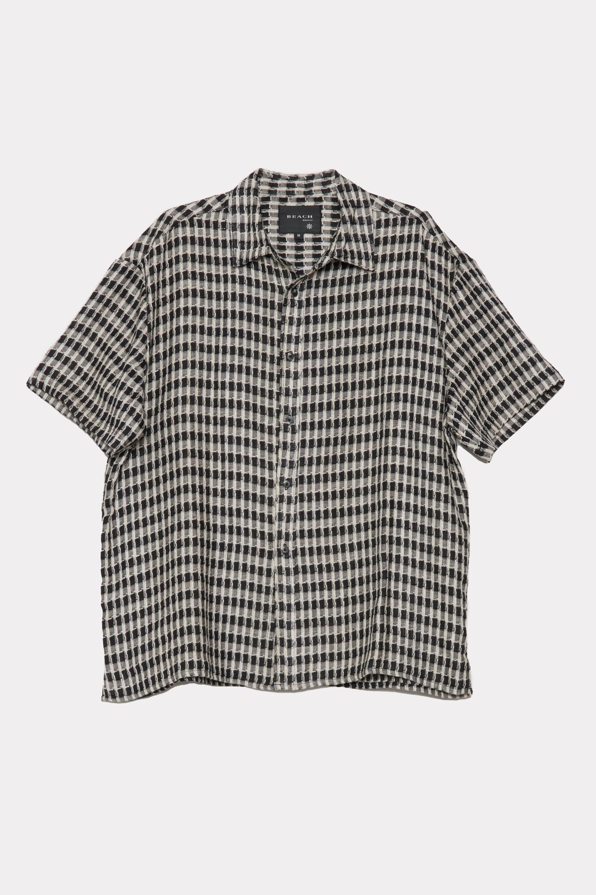 Black and white checkered shirt on a light grey background