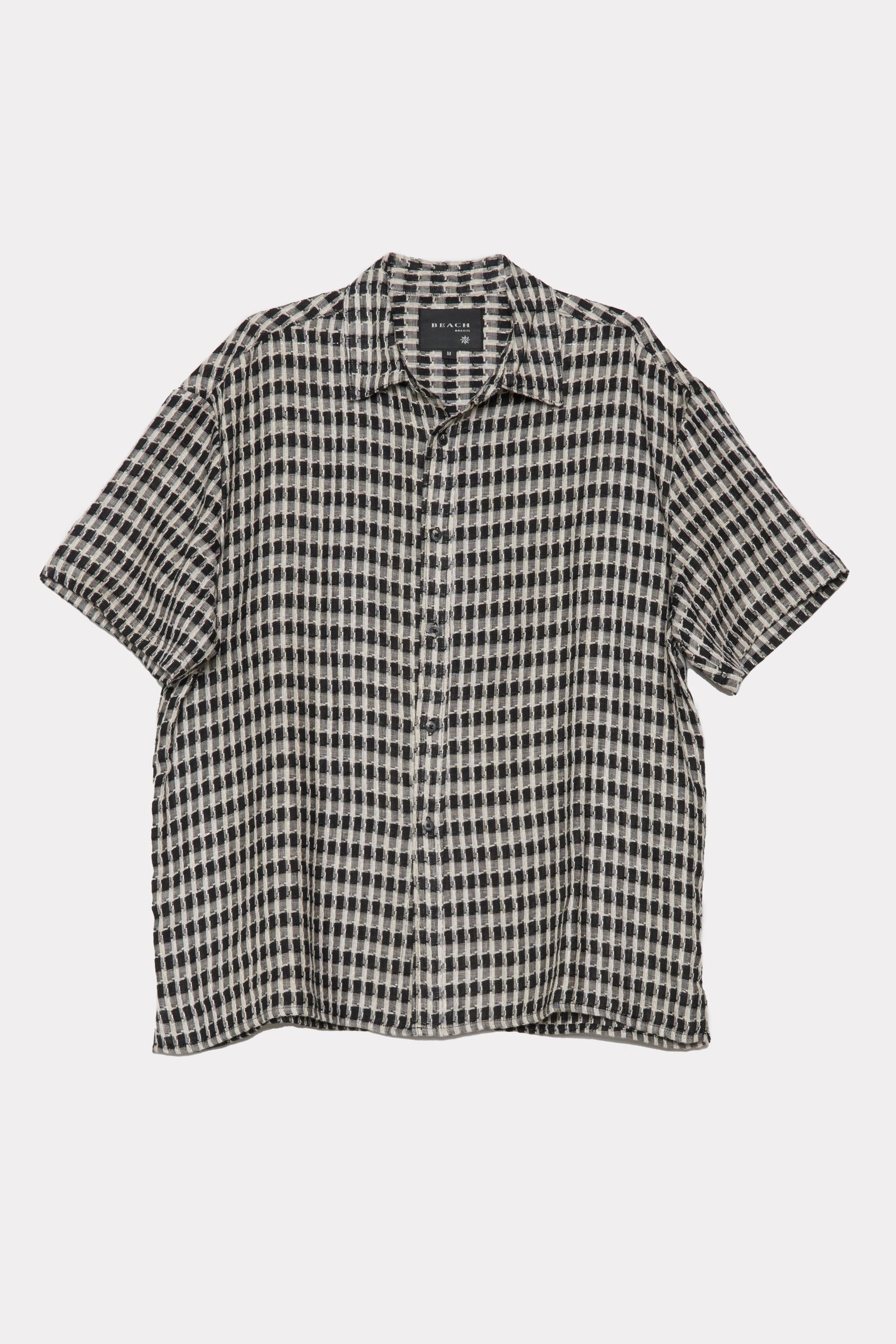 Black and white checkered shirt on a light grey background