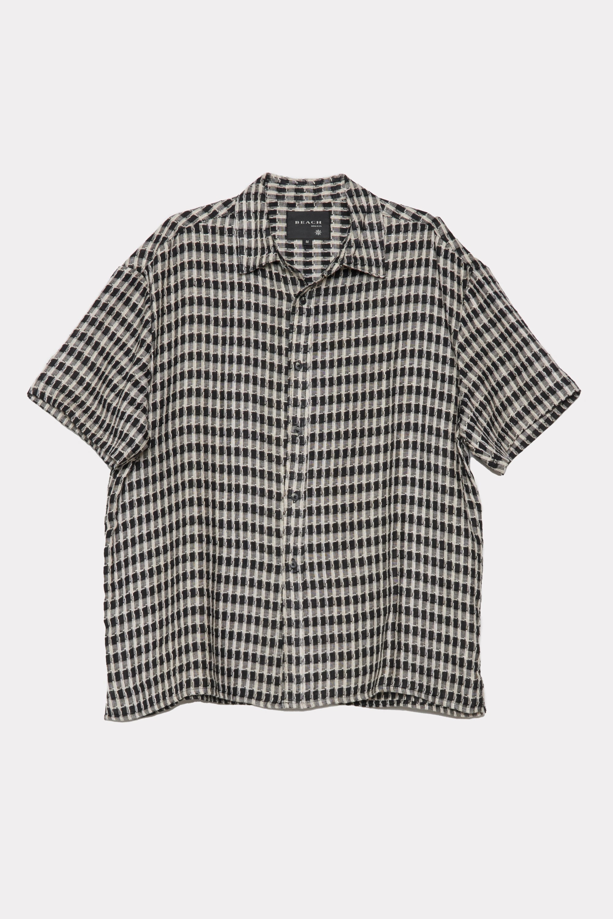 Black and white checkered shirt on a light grey background
