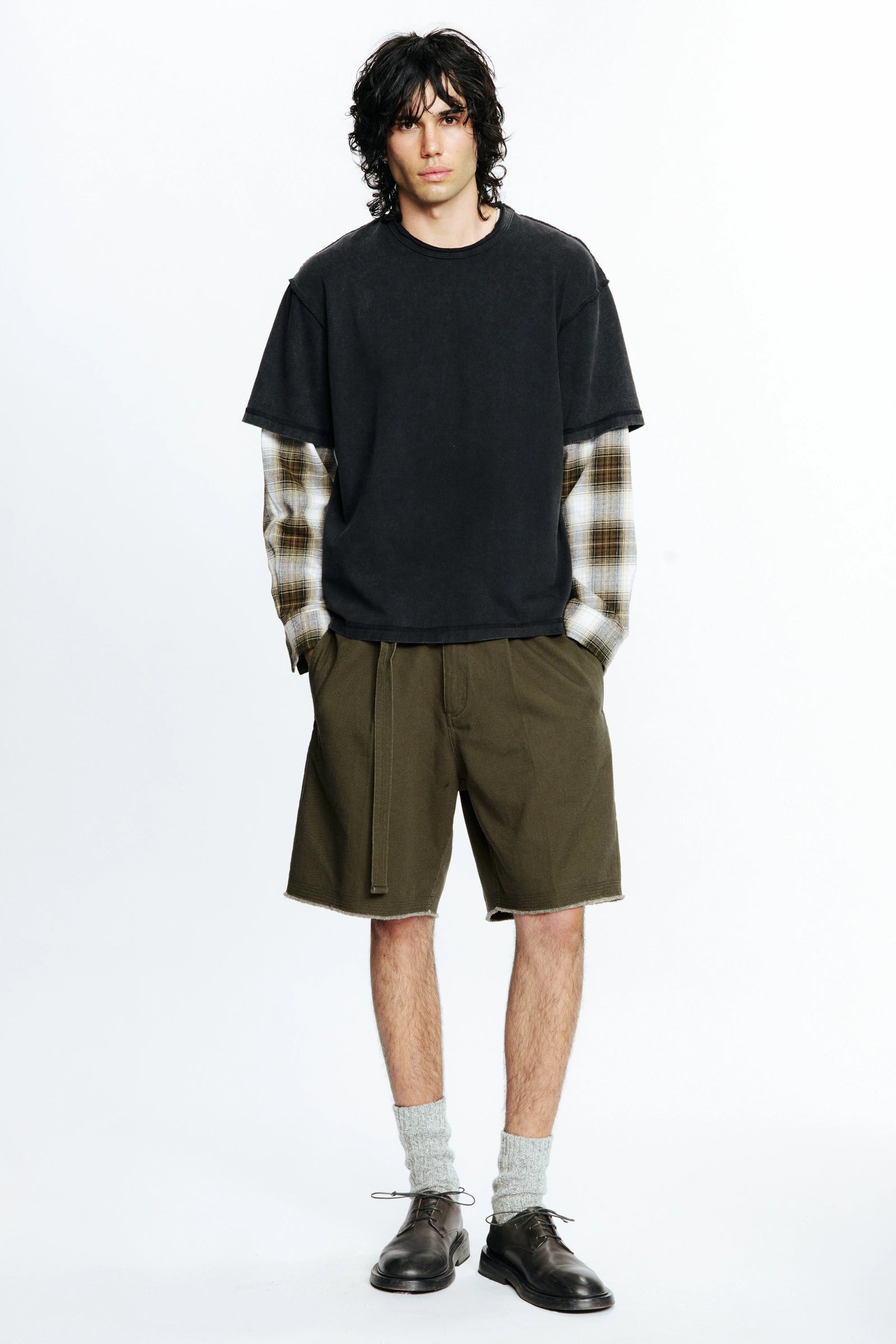 Person wearing a black t-shirt and the Beach Brains Daily Shorts in green colour on a white background