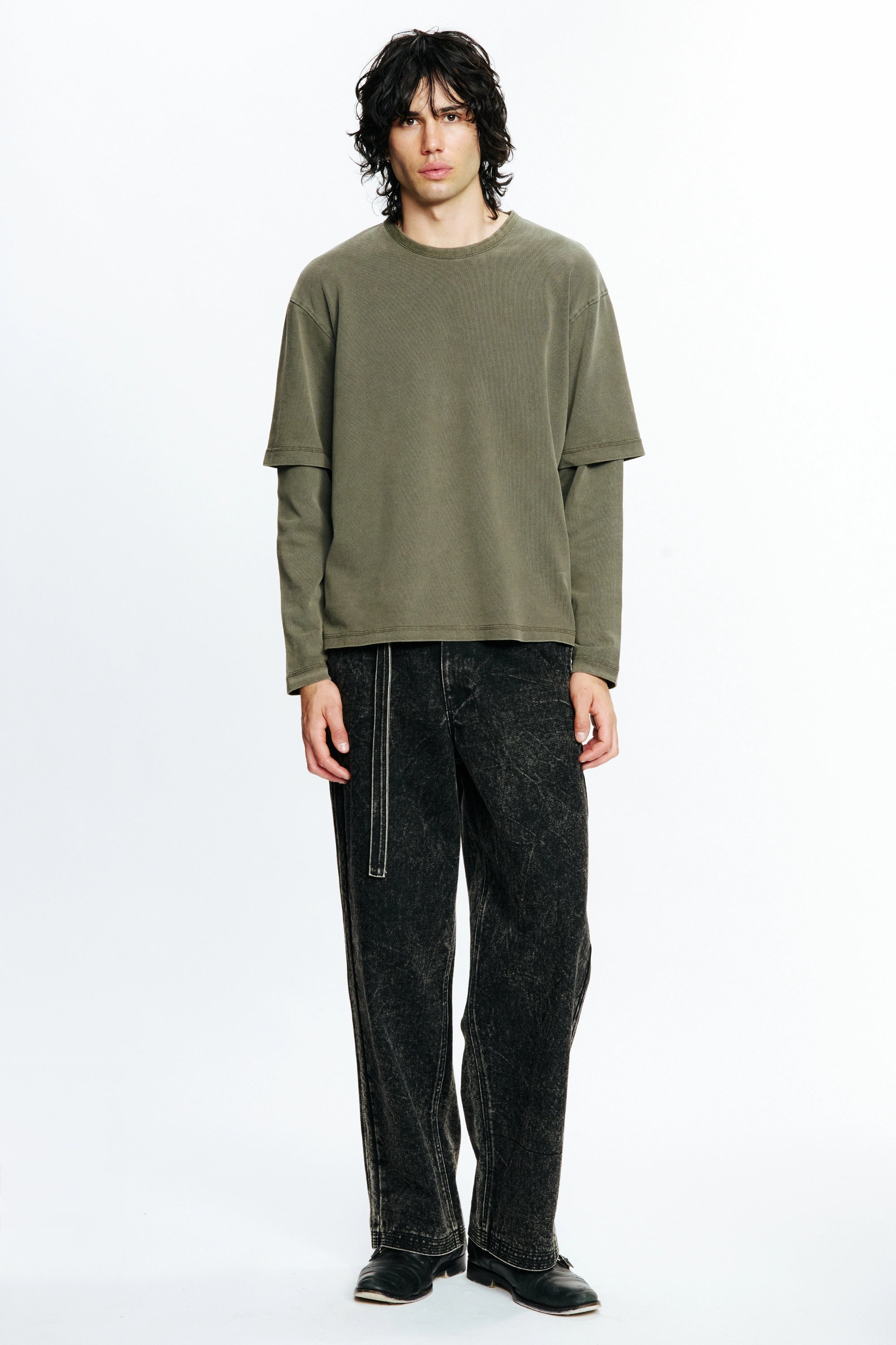 Person wearing a Fatigue Dream Layer Long Sleeve Shirt and black jeans on a white background