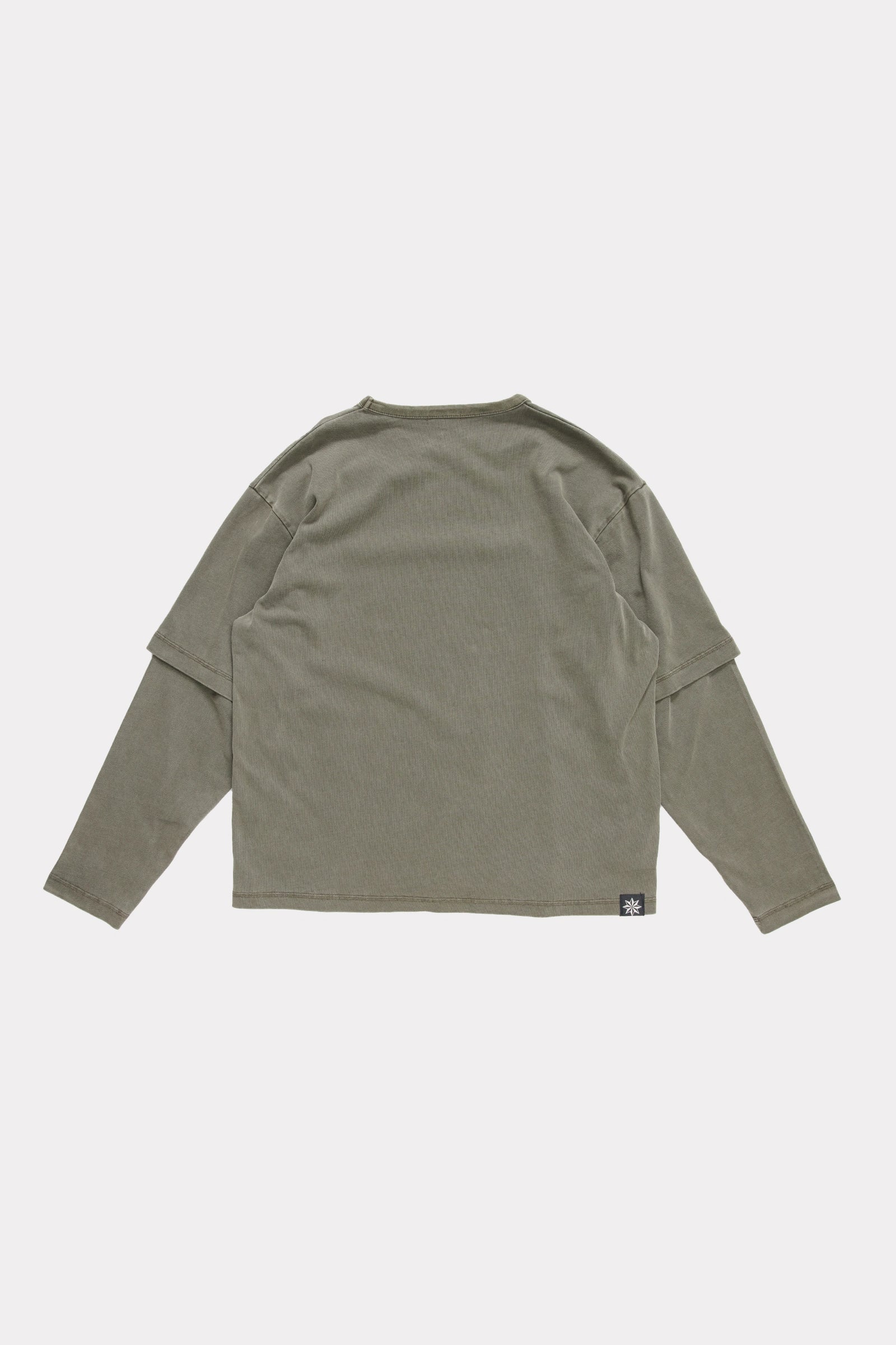 View of the back of a Fatigue Dream Layer Long Sleeve Shirt on a light grey background