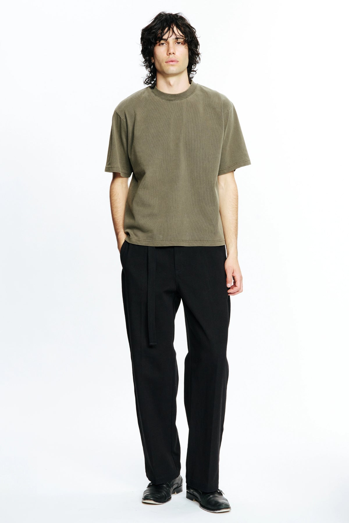 Person wearing a Fatigue Dream T-Shirt and black pants on a white background