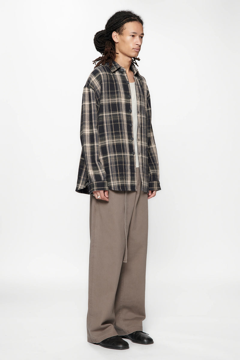 Person wearing a Navy Check Drop Long Sleeve Shirt and beige pants on a white background