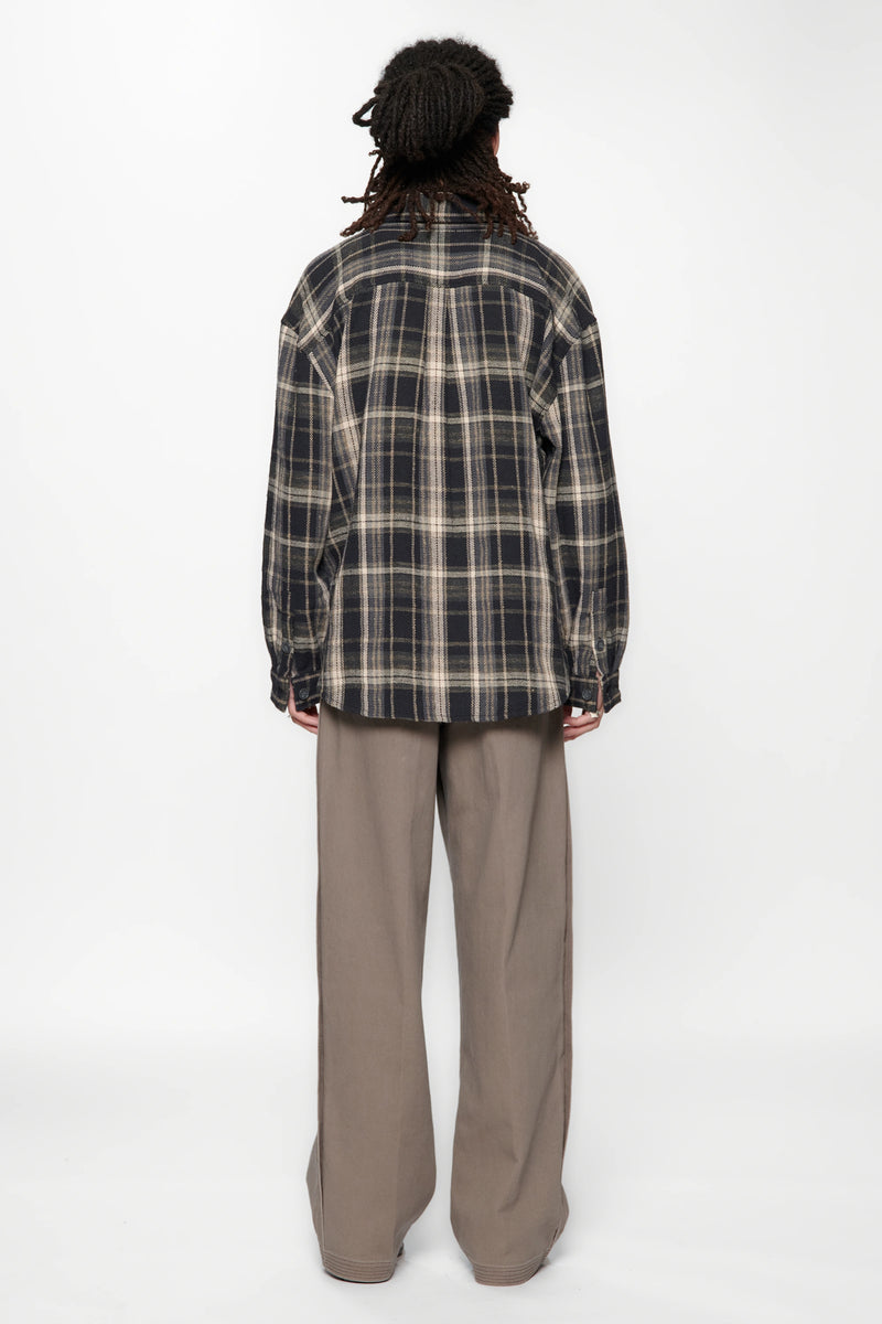 View from behind of a person wearing a Navy Check Drop Long Sleeve Shirt and beige pants on a white background