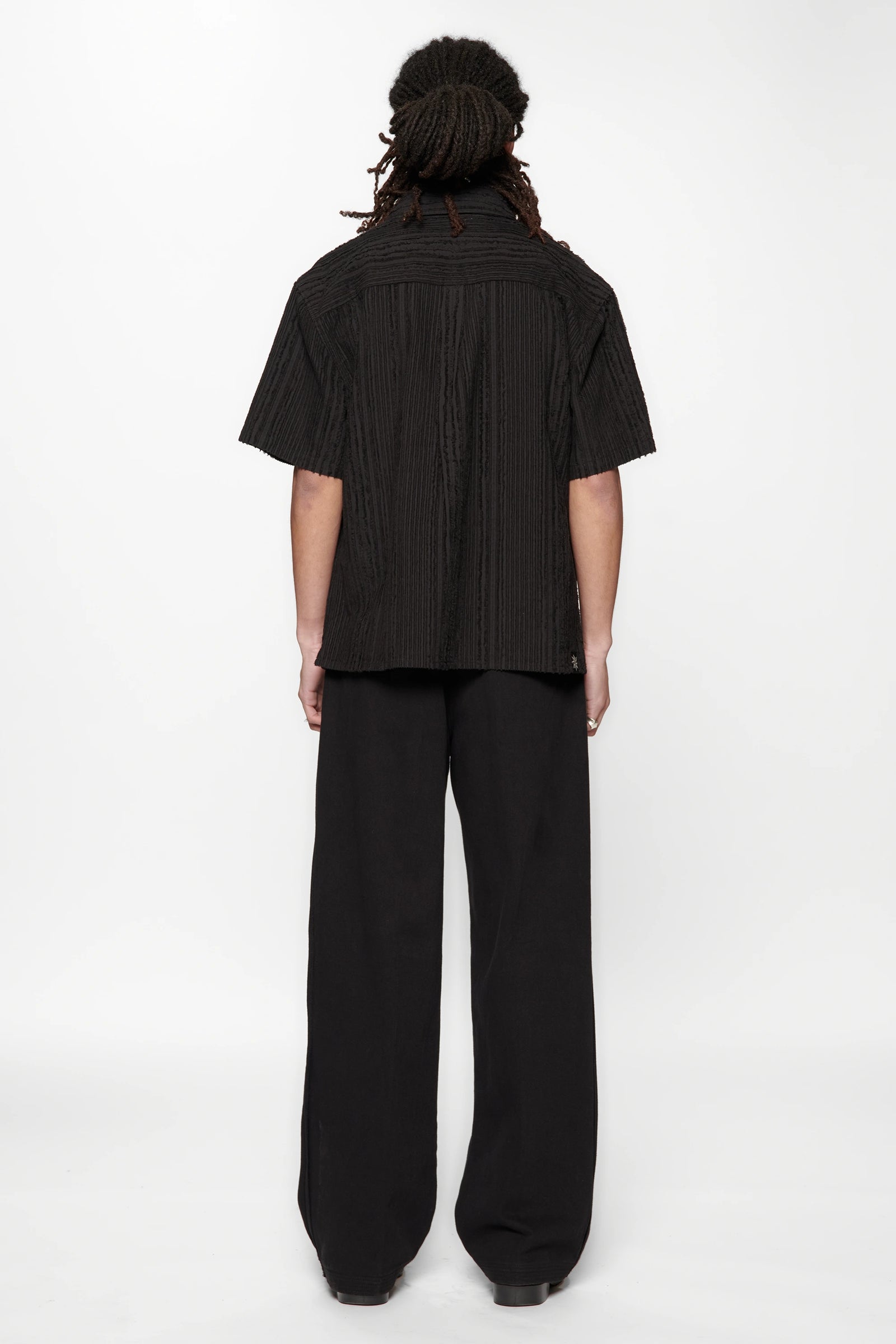 Behind view of a person wearing the Hold SS Shirt in Black Tux on white background