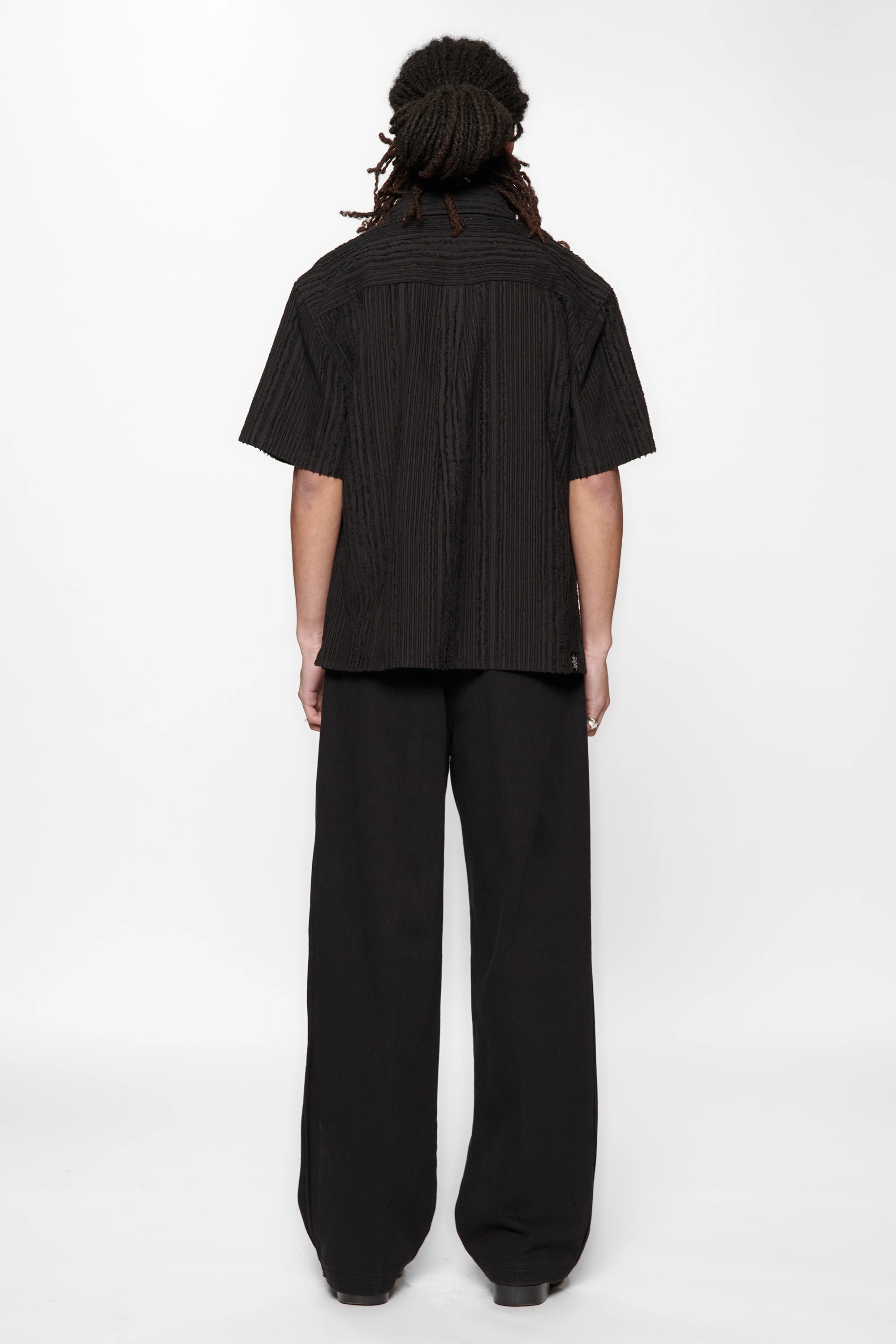 Behind view of a person wearing the Hold SS Shirt in Black Tux on white background