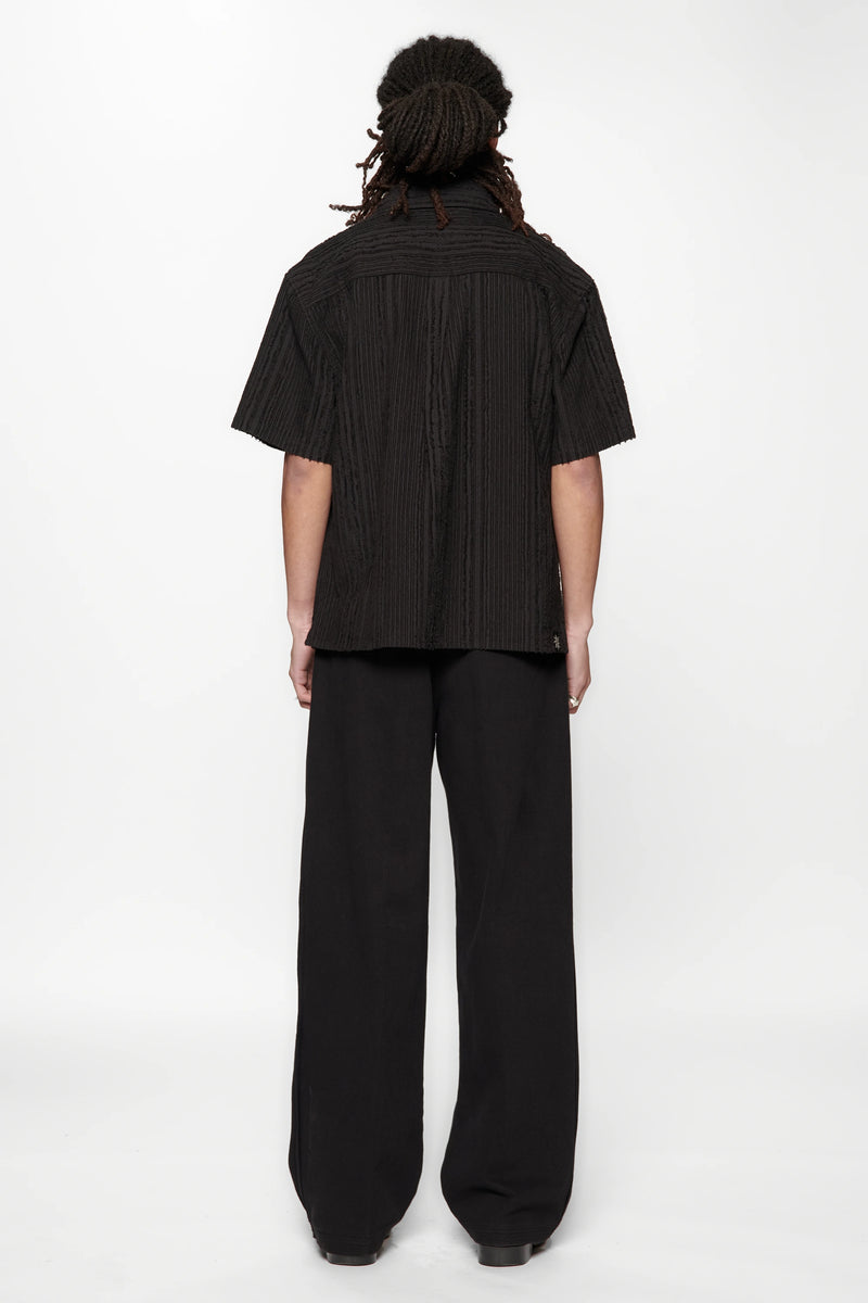 Behind view of a person wearing the Hold SS Shirt in Black Tux on white background
