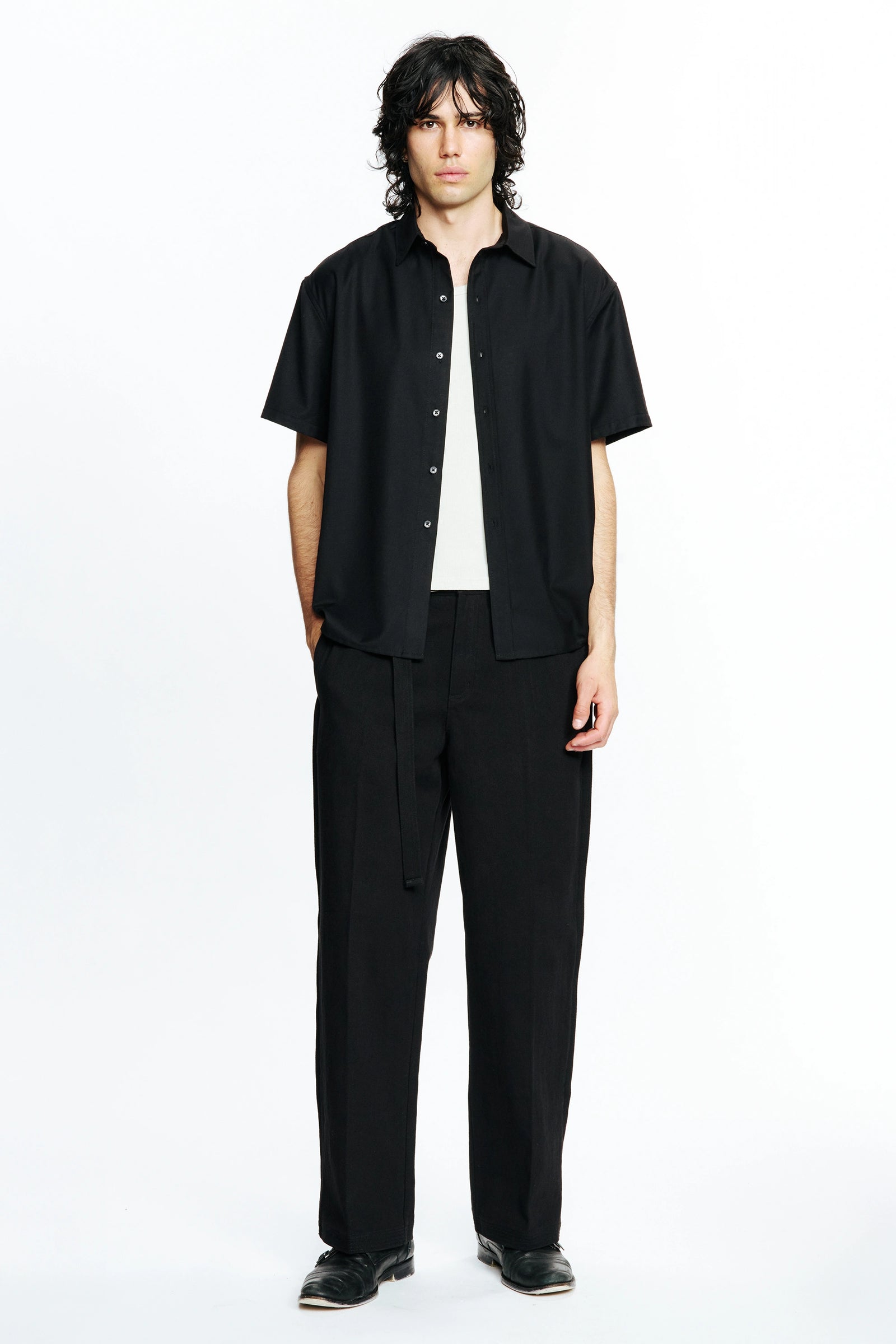 Person wearing a Black Hold Short Sleeve Shirt and pants on a white background