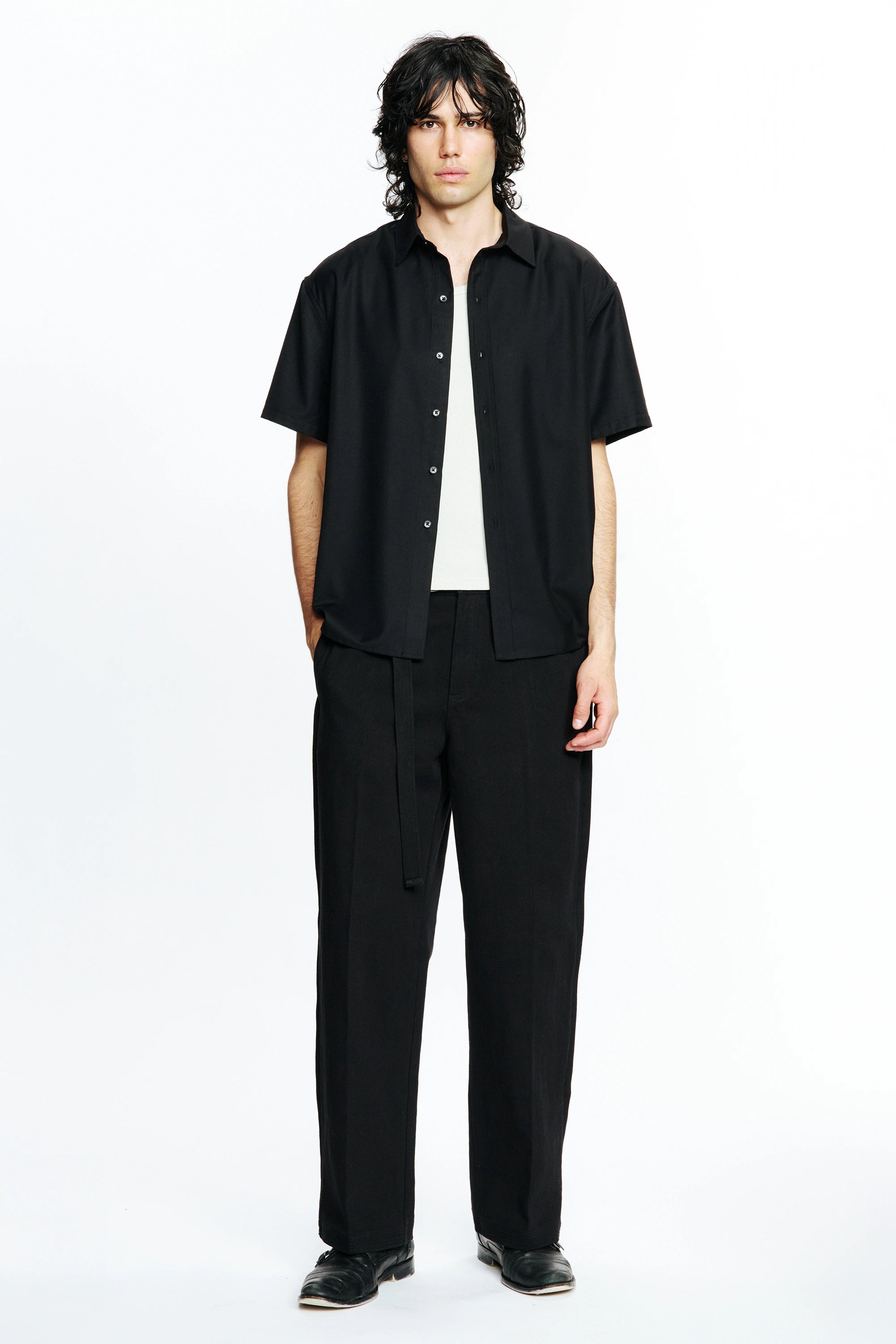 Person wearing a Black Hold Short Sleeve Shirt and pants on a white background