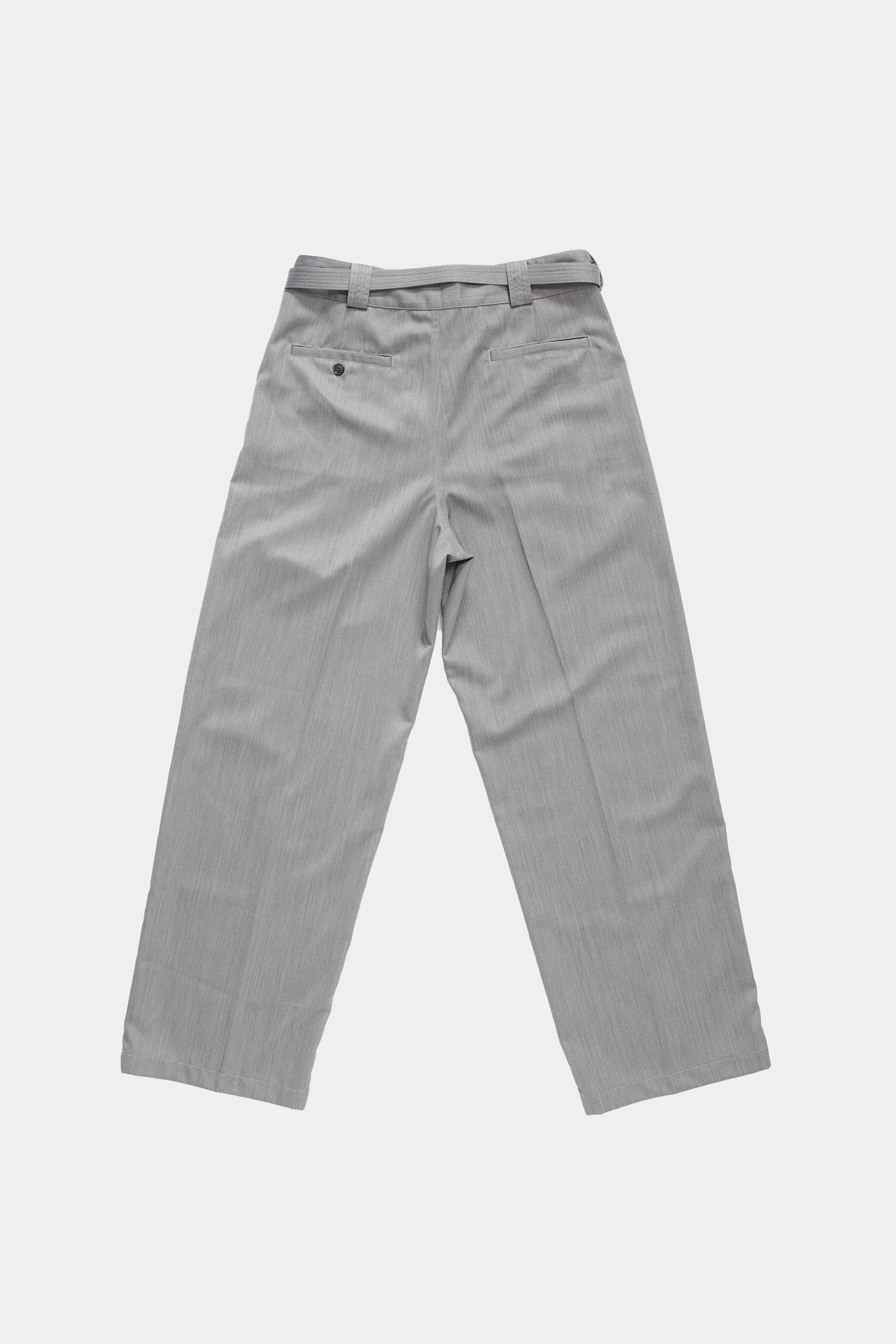 View from behind of grey trousers on a white background