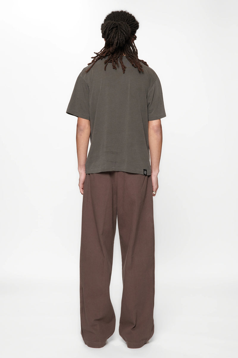 Rear view of a male wearing  the Dark Grey Pleated Work Pants by Beach Brains