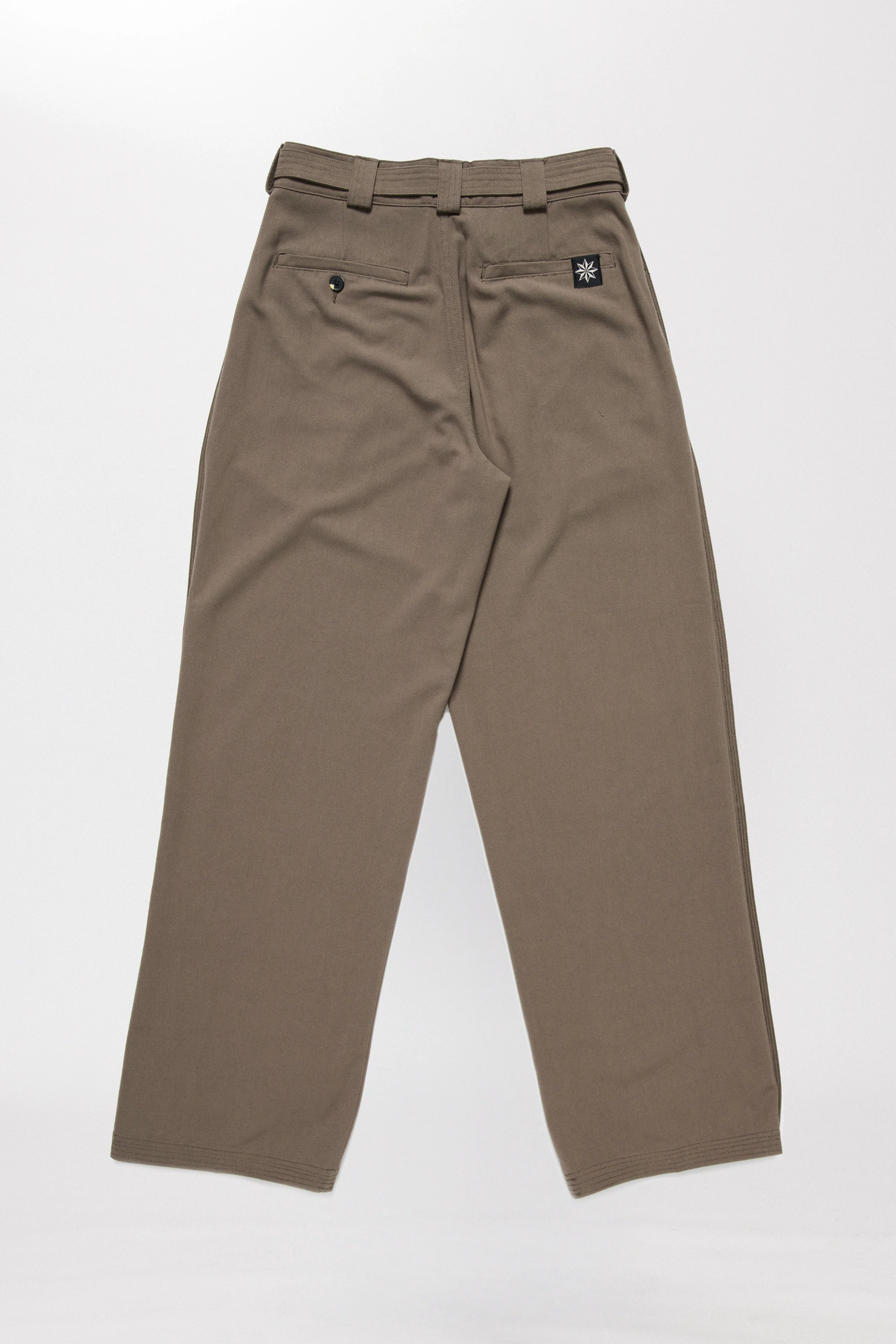 Rear view of a pair of chocolate brown pleated work pants on a white background